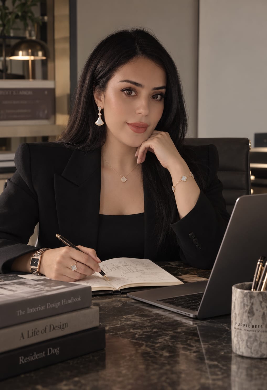 Portrait of the person behind Purple Bees, seated at a desk with a sketchbook